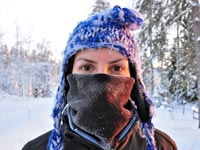 What are the risks of getting frostbite when dog sledding or ski touring?