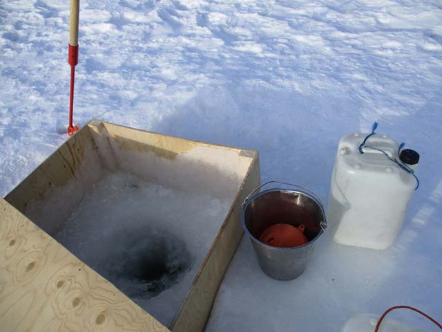 Fetching water from a hole in the ice is a central part of cabin life on many of our dogsled tours.
