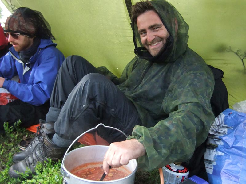 Euan enjoys the simple pleasures - a hot meal never tasted so good! Canoeing in Rogen, Sweden. Photo: Nature Travels.
