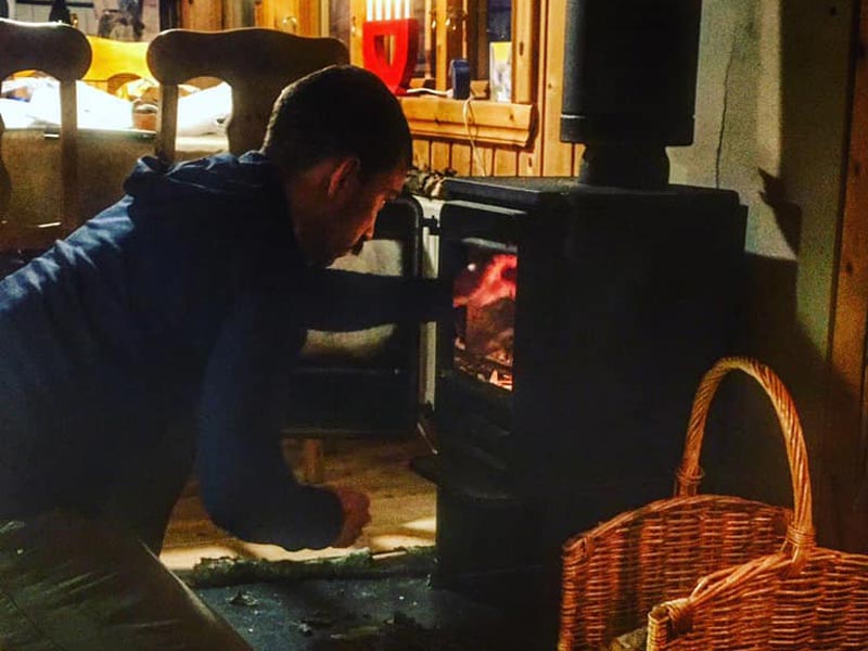 Preparing the fire at the Log Cabin Escape