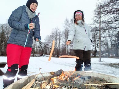 Taking a break to grill sausages over the fire | Photo: SA